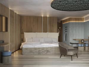 Lehrlingsportal.at Modernes Hotelzimmer mit großem Bett, Holzwänden, einem an der Wand montierten Fernseher und einem gemütlichen Sessel. Das Zimmer ist minimalistisch eingerichtet und hat sanftes, natürliches Licht.
