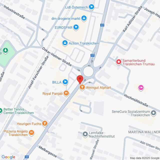 Lehrlingsportal.at Die Karte zeigt einen Kreisverkehr an der Kreuzung Oskar-Helmer-Straße und Karl-Adolf-Straße in Traiskirchen, Österreich, mit Beschriftung der umliegenden Geschäfte und Wahrzeichen.