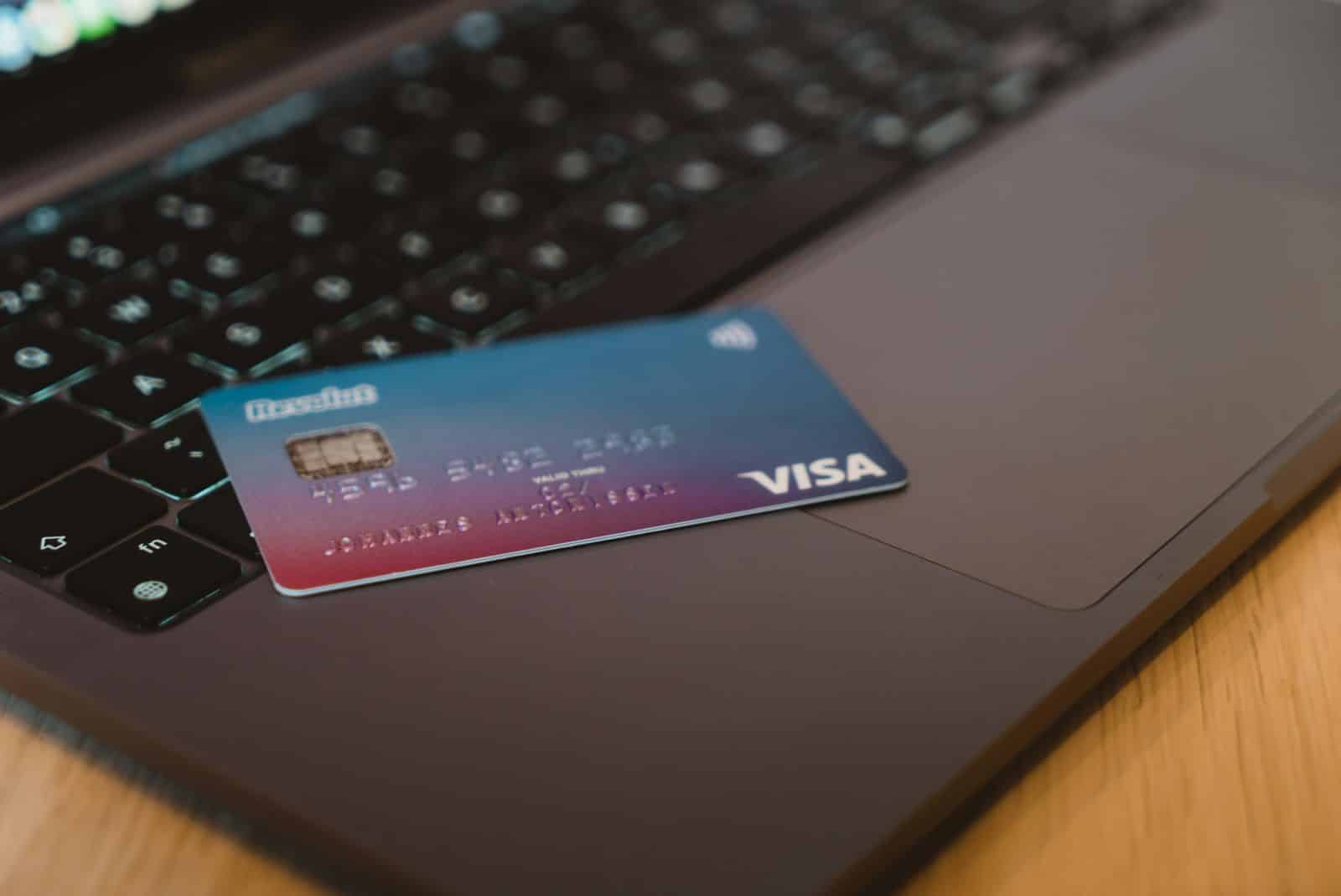 Lehrlingsportal.at Eine Visa-Debitkarte liegt auf der Tastatur eines offenen Laptops.
