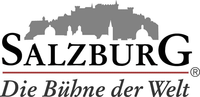 Lehrlingsportal.at Logo mit einer grauen Silhouette der Salzburger Skyline über dem Wort „Salzburg“. Darunter steht in Rot und Schwarz: „Die Bühne der Welt.“.