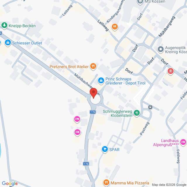 Lehrlingsportal.at Eine Karte, auf der ein roter Standortpin an einem Kreisverkehr in Kössen, Österreich, zu sehen ist, umgeben von örtlichen Geschäften und Straßen.
